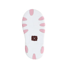 A white shoe sole with pink petal-like cutouts and a small brown square patch with a white X logo in the center, shown on a plain white background.